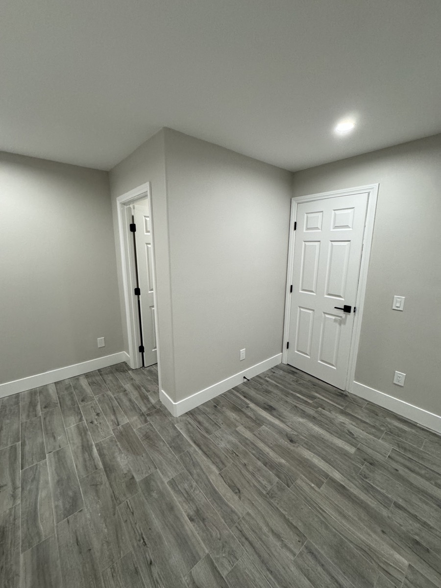 Bedroom suite with wood-look tile floor
