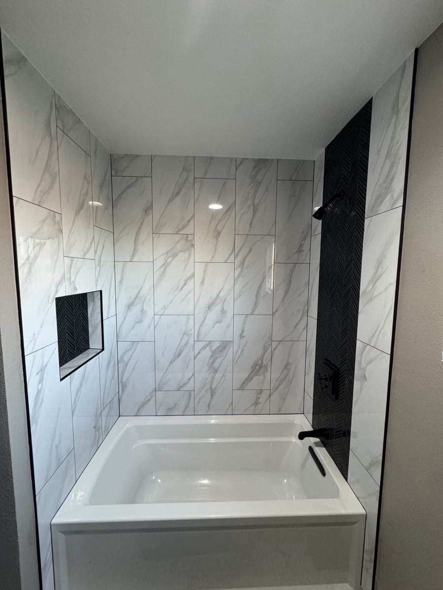 Marble tub surround with herringbone accent